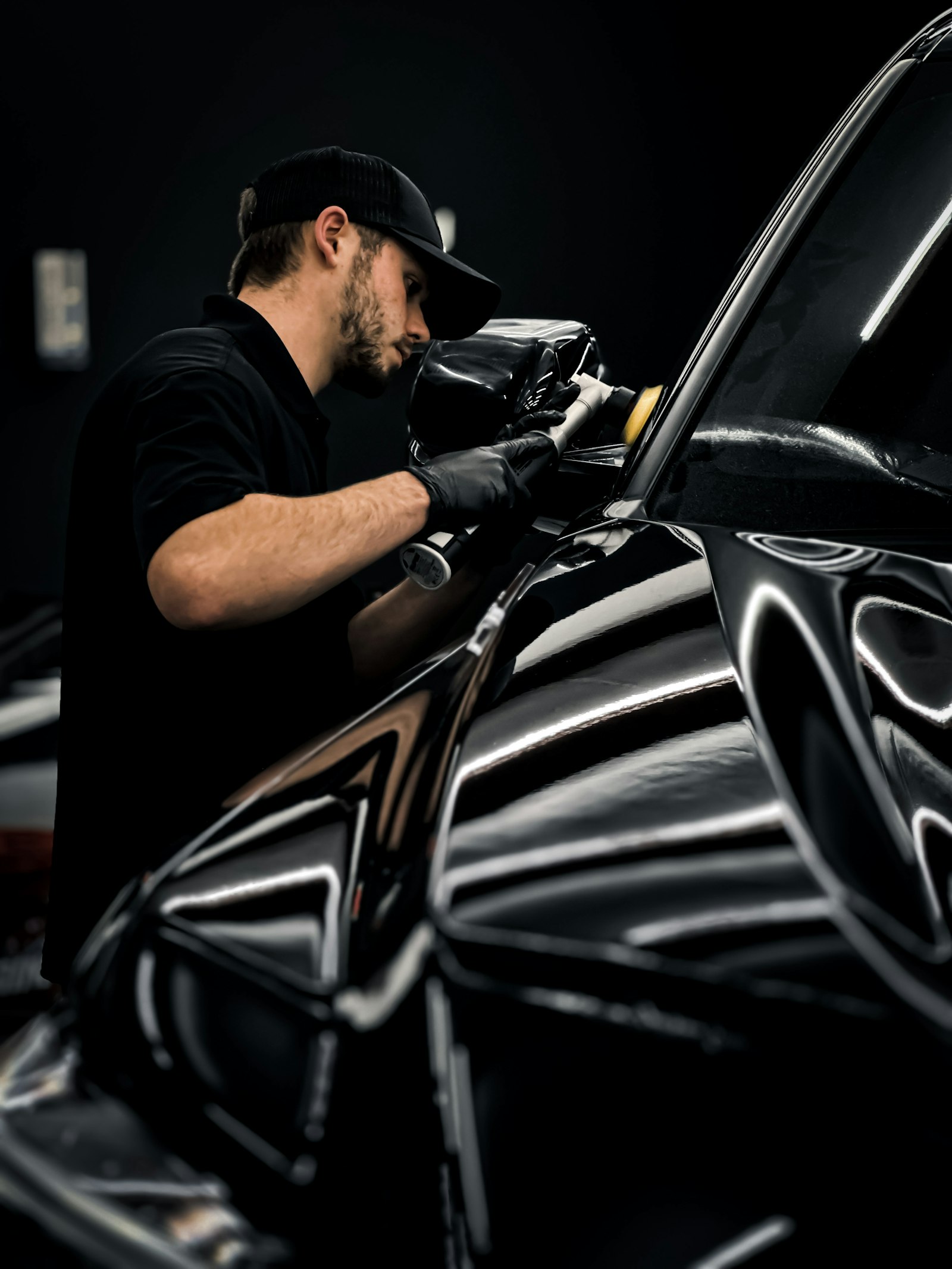Detailer polishing a car body panel