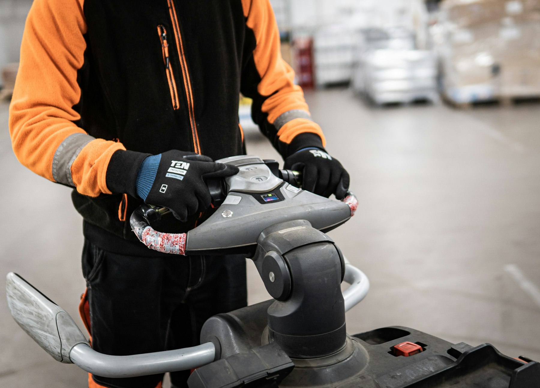 Operator running a floor scrubbing machine